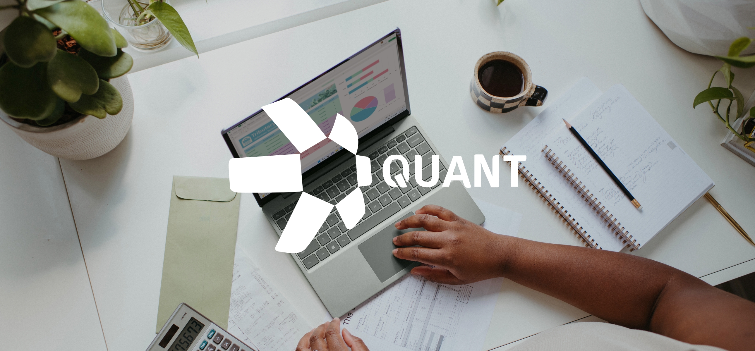Quant logo on top of photography showing a laptop